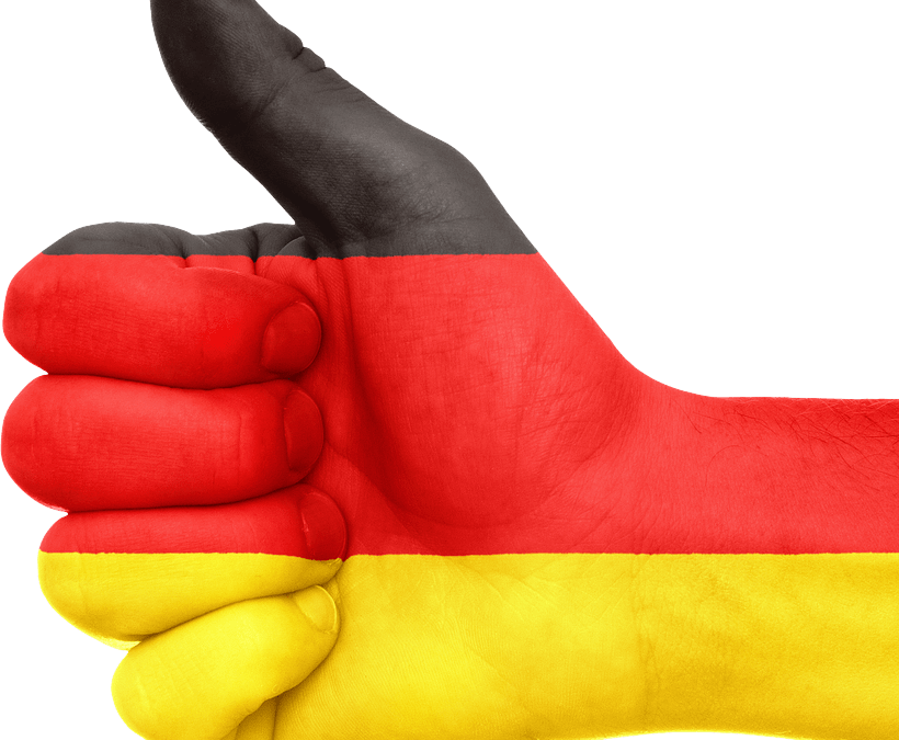 Mano con el pulgar hacia arriba y la bandera de Alemania pintada. Traducciones perfectas en alemán